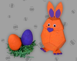 Papierostereier mit Osterhase aus Papier Bild von zwei Papierostereiern neben orangefarbenem Osterhasen