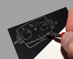 Aufkratzen auf Schabekarton Bild vom Aufkratzen eines Kopfes auf Schabekarton