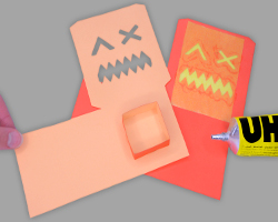 Bild vom Aufeinanderkleben der beiden Tonpapiergesichter